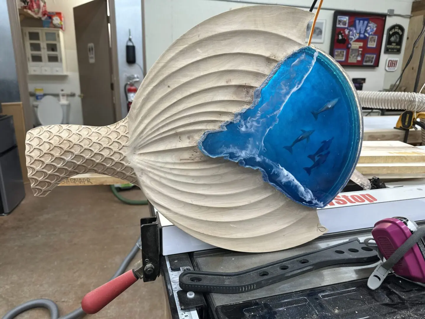 Wood carving with blue resin ocean and sharks
