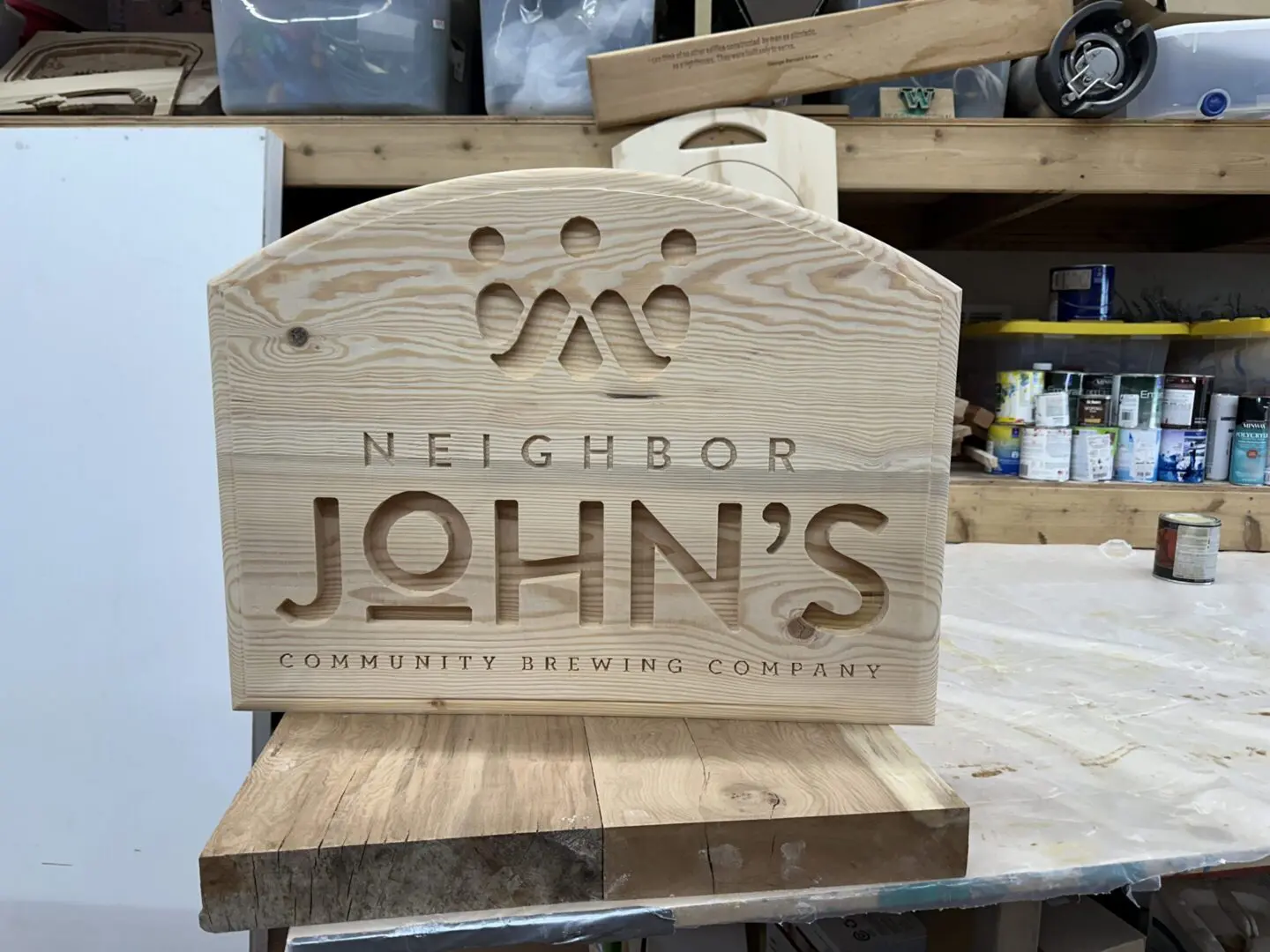 Wooden carved sign for Neighbor John's Community Brewery