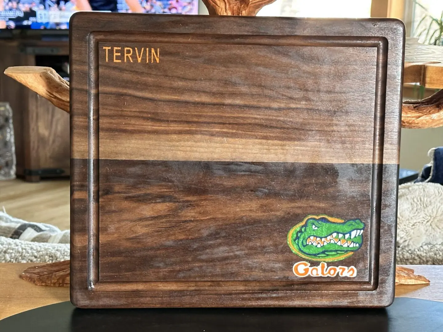 Engraved wooden cutting board with Gators logo
