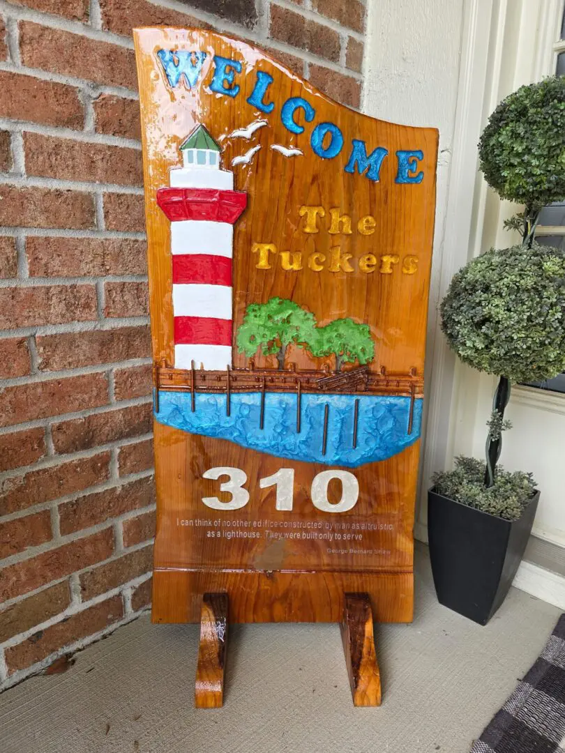 Wooden lighthouse welcome sign on porch