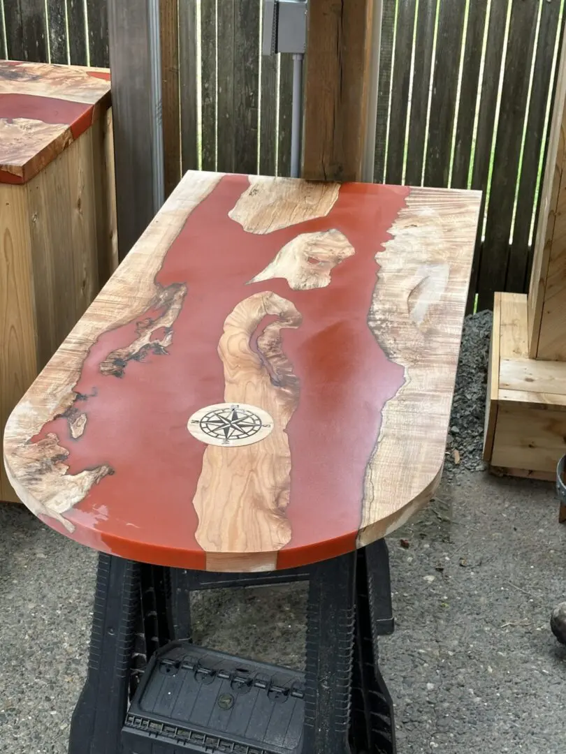 Live-edge wooden table with red epoxy river