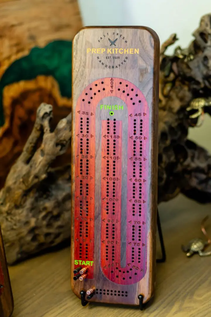 Colorful wooden cribbage scoring board