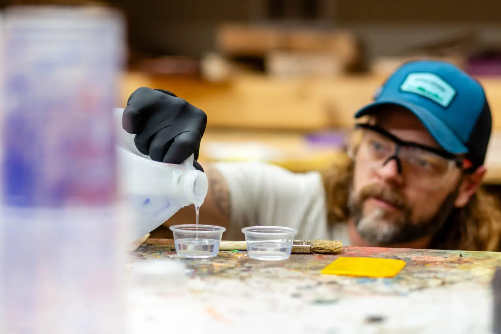 Worker pouring liquid into plastic cups