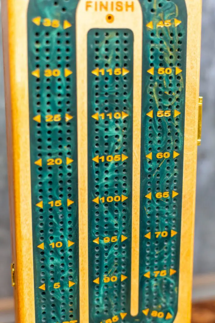 Wooden cribbage board with numbered holes